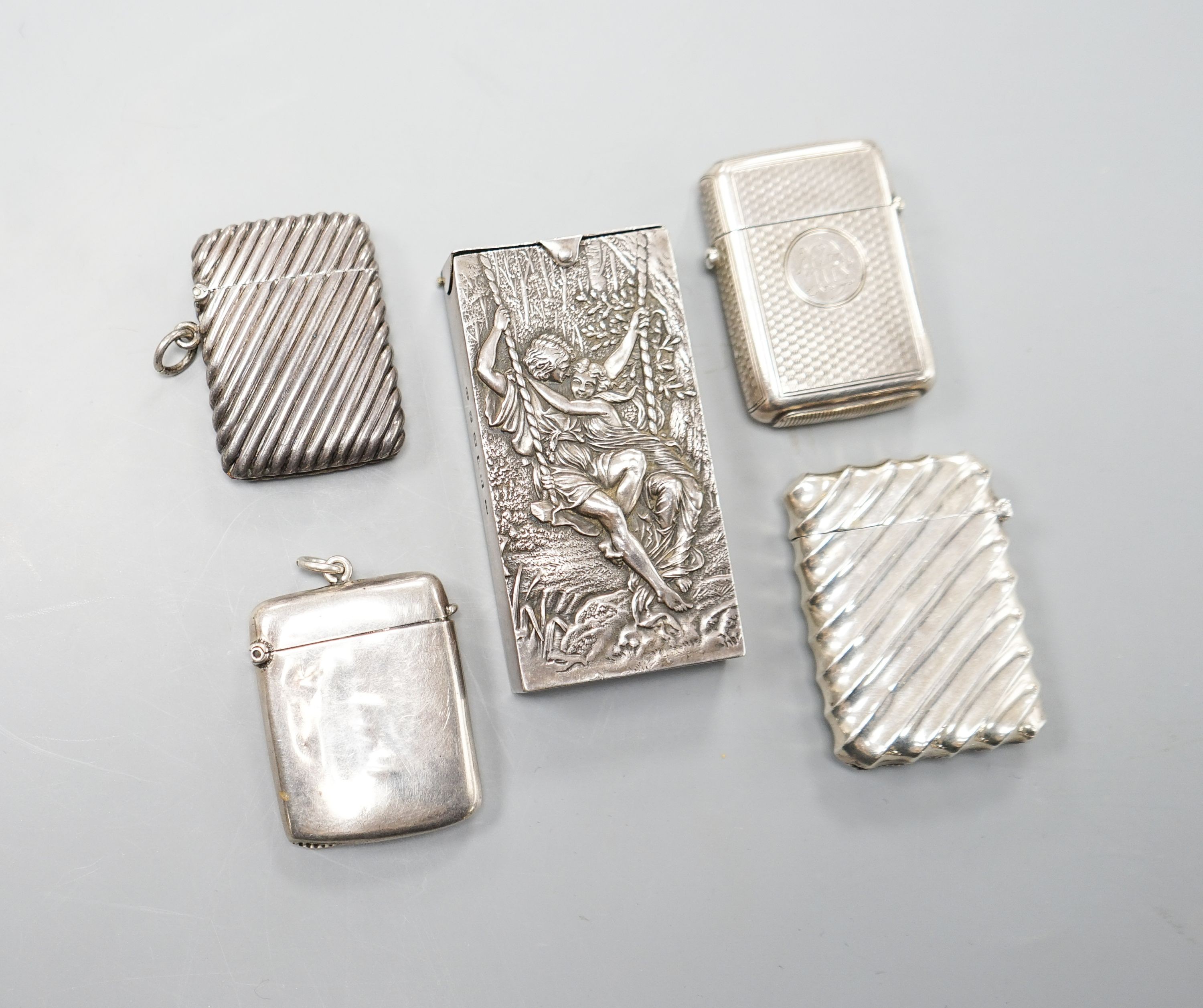 Four assorted silver vesta cases, largest 56mm and a late Victorian repousse silver rectangular box.